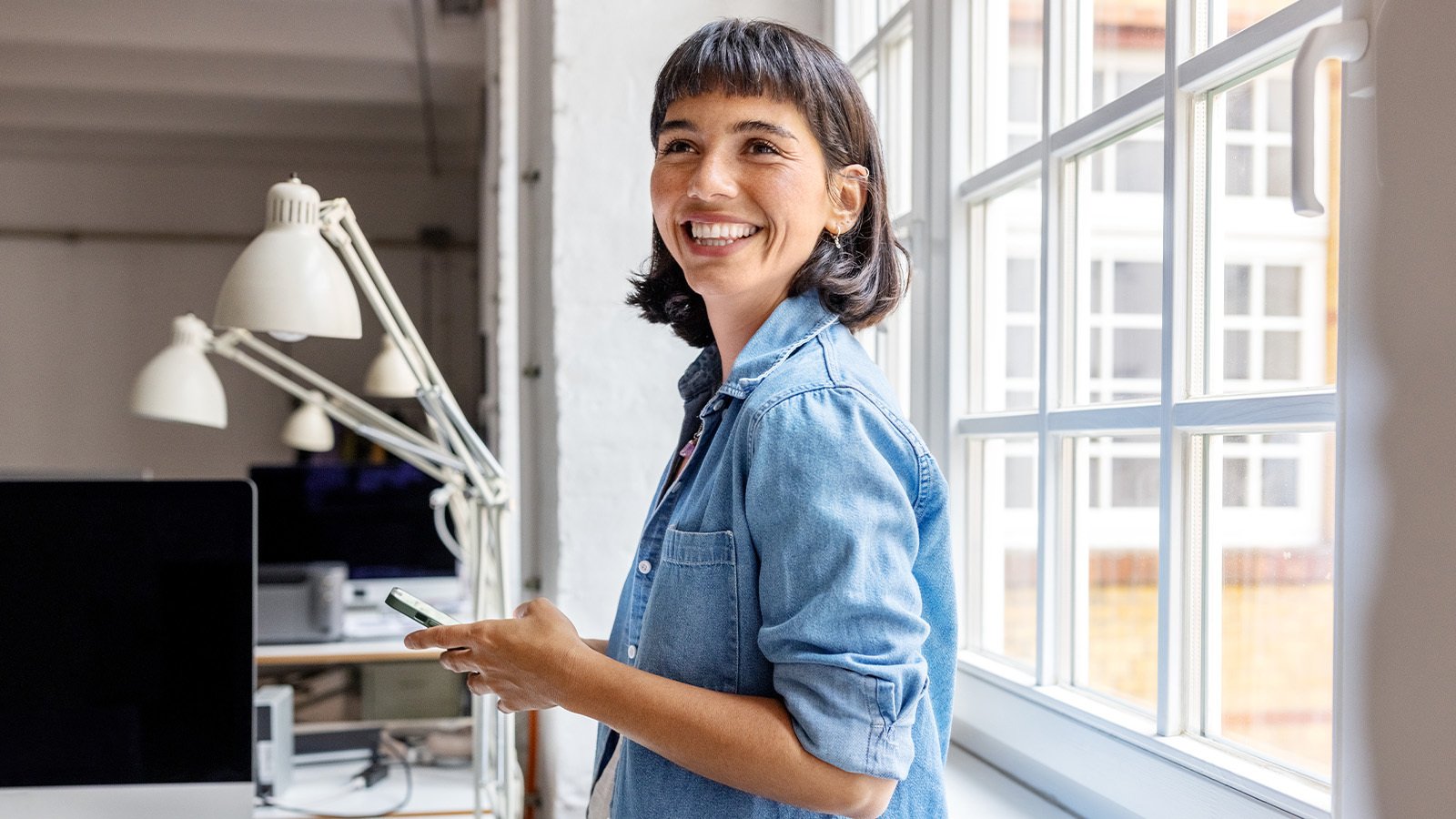 woman using phone in office